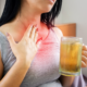 An image of a woman with acid reflux rubbing her reddened neck.