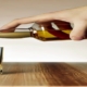 An image of a hand pouring alcohol beverage into a glass.