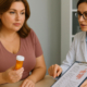 Contrave and Zyvox Drug Interactions symbolized by a concerned patient discussing a bottle of medication with her doctor.